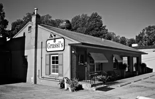 A black and white photo of the outside of grissis.