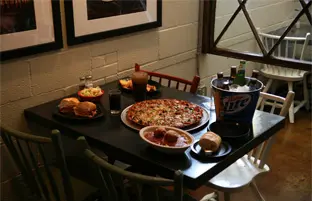 A table with pizza and other food on it